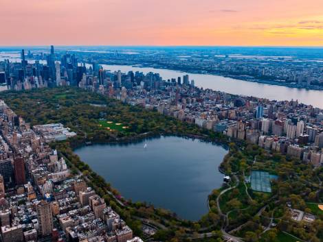 Scenic view of Central Park in the cityscape of New York, the USA. Aerial perspective. Enormous city panorama at sunset.